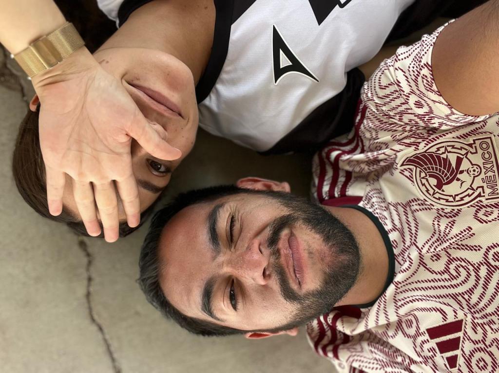 [two men lying on the floor wearing soccer jerseys].